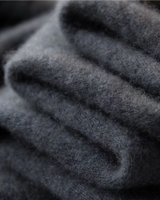 Serpentine-folded texture of the Men's Luxury Albas Cashmere Cardigan in Dune, showcasing its soft cashmere material and elegant drape. From Borcelleclothes.