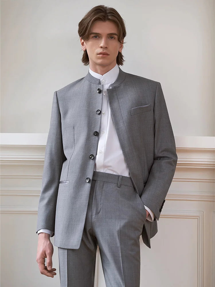 Model dressed in the Borcelleclothes Men's Mandarin Collar Wool Ensemble in Oslo Grey, with one hand in the pant pocket, displaying the light and elegant tone of the suit.