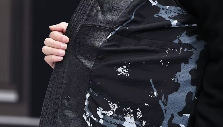 Model in Onyx jacket opens front to show interior patterned lining. From Borcelleclothes.