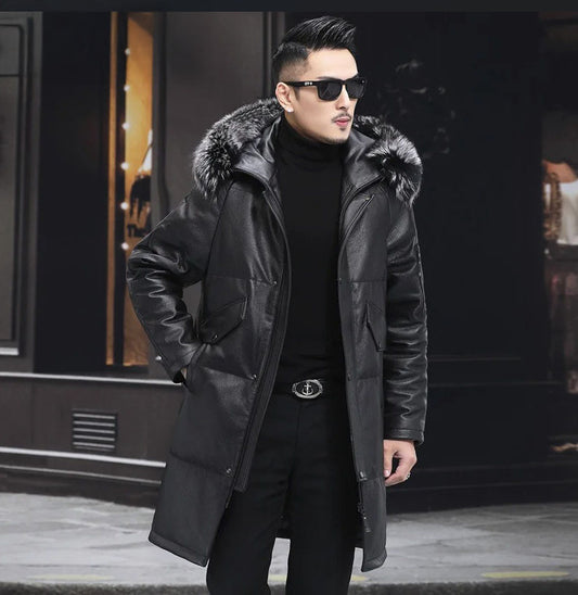 Men’s mid-thigh cowhide jacket in matte Onyx with raglan sleeves, fox-style fur hood, and double-layered front placket, blending internal structure with understated softness. From Borcelleclothes.