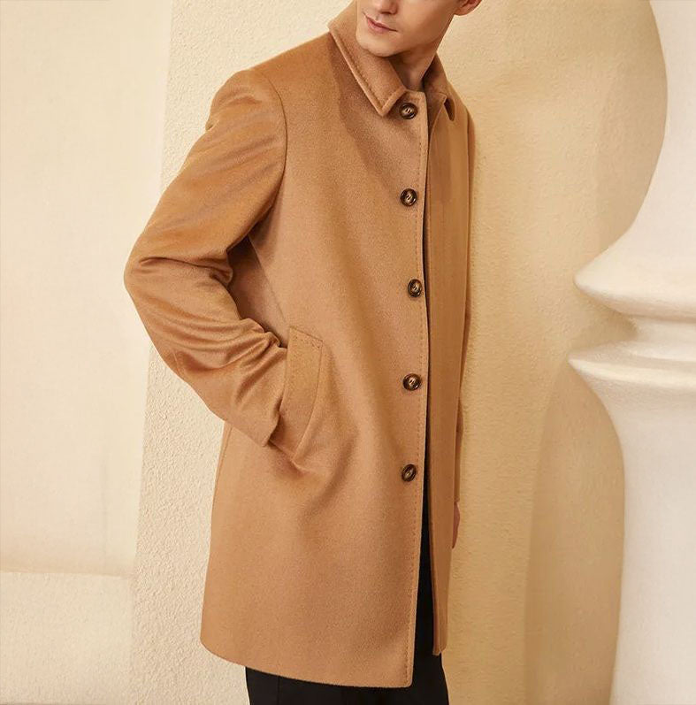 Men’s Minimalist Cashmere Coat in Burning Sand, crafted from a premium blend of 70% cashmere and 30% high-count wool. Featuring a sleek single-breasted design, structured set-in sleeves, and a refined visible upper button for a modern, minimalist aesthetic. From Borcelleclothes.