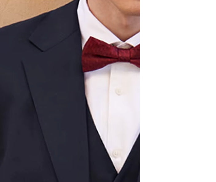 Model dressed in the Borcelleclothes Men's Modern Gentleman’s Ebony Clay Suit, wearing a bow tie, focusing on the blazer's notch lapels and single-welt chest pocket.