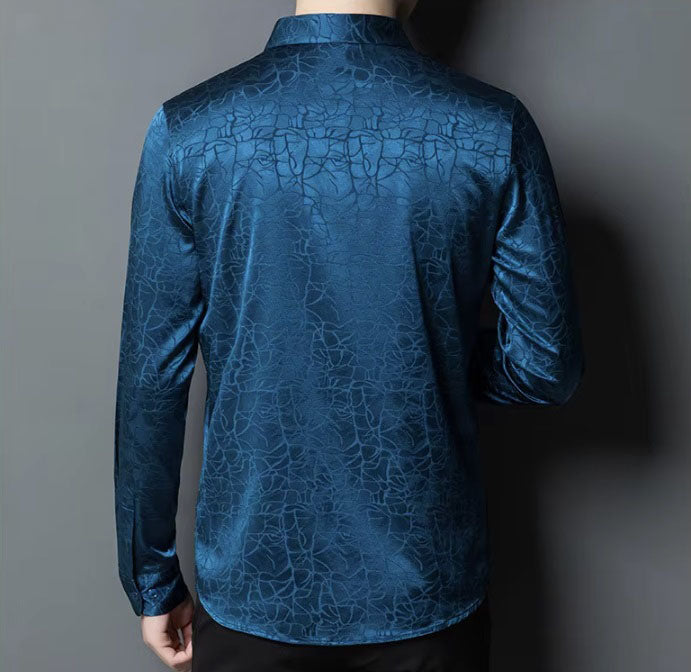 The back of the Men's Mulberry Silk Shirt in Chathams Blue, featuring an earth-inspired pattern with a dynamic interplay of matte and shiny finishes, crafted from 92.4% Mulberry silk and 7.6% spandex, ideal for formal and semi-formal occasions. From Borcelleclothes.
