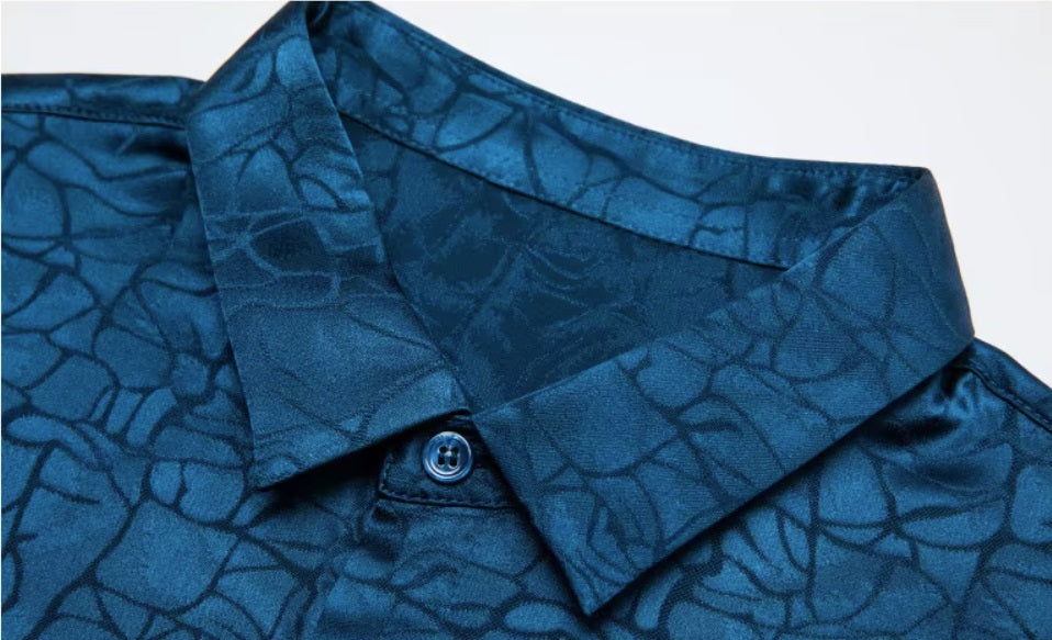 Detailed stitching and textured fabric on the collar of the Men's Mulberry Silk Shirt in Chathams Blue, featuring an earth-inspired pattern with a dynamic interplay of matte and shiny finishes, crafted from 92.4% Mulberry silk and 7.6% spandex, ideal for formal and semi-formal occasions. From Borcelleclothes.