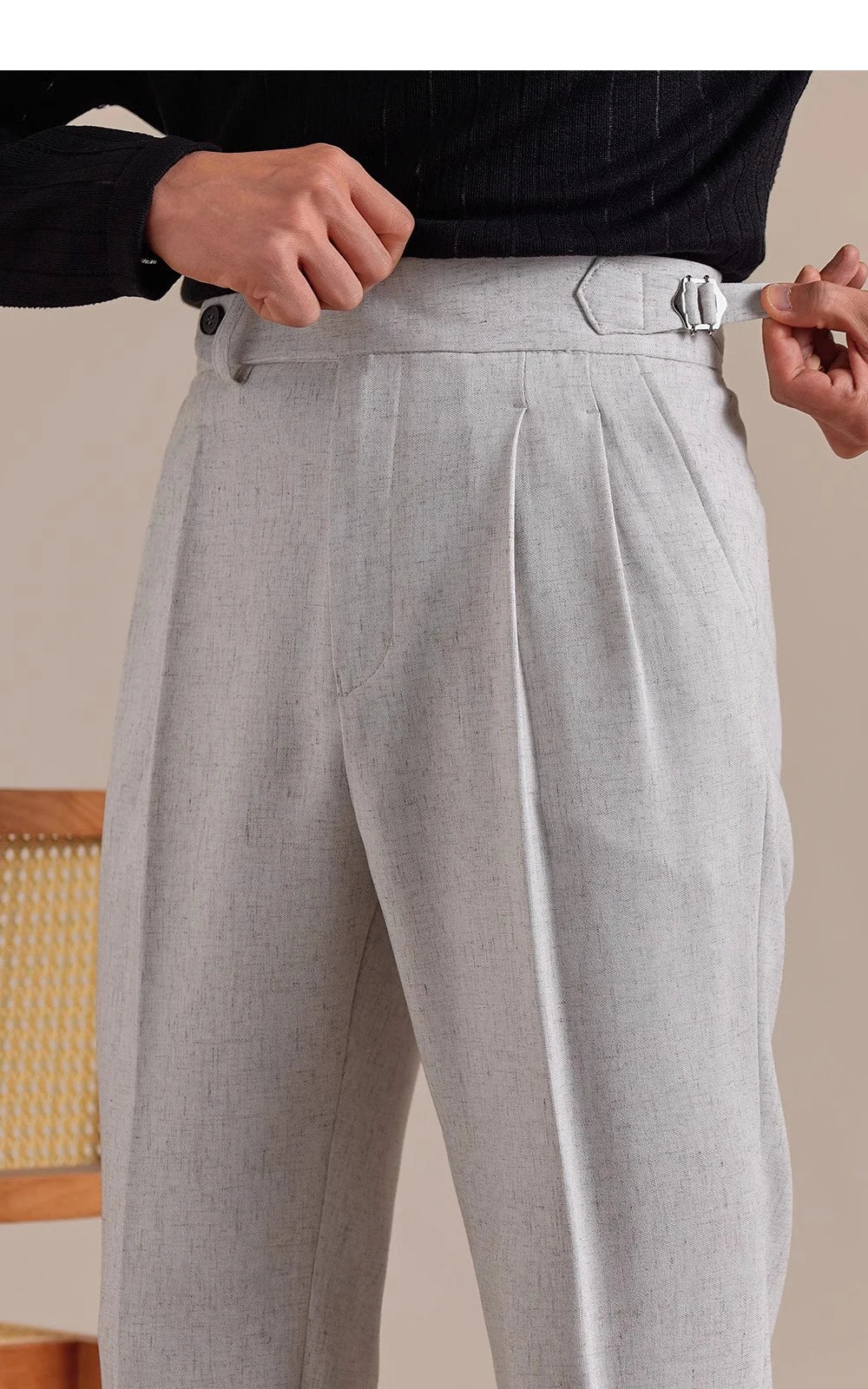 Model adjusts side tab on cropped Nobel trousers—highlighting discreet tailoring and built-in waist regulation. From Borcelleclothes.