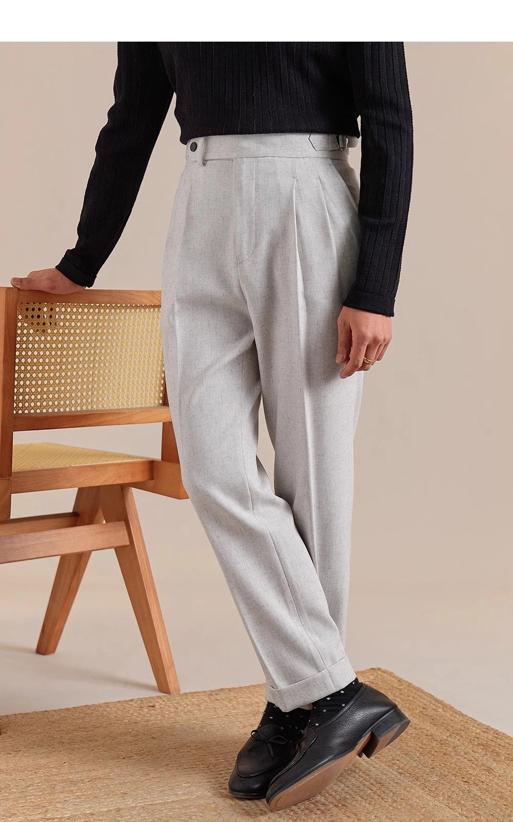 Model crosses legs in Nobel trousers—emphasizing relaxed structure, cuffed hem, and quiet formality. From Borcelleclothes.