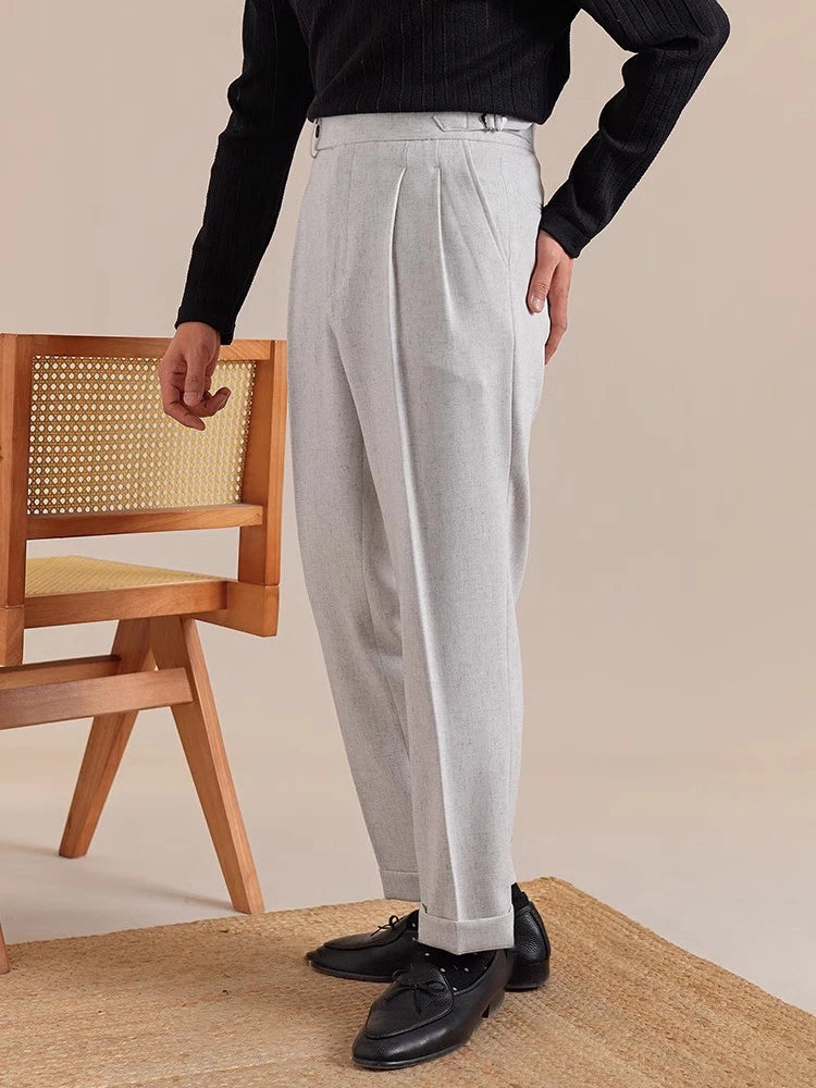 Model in Nobel trousers with hand on hip—showing clean waistline, side adjusters, and softly structured stance. From Borcelleclothes.
