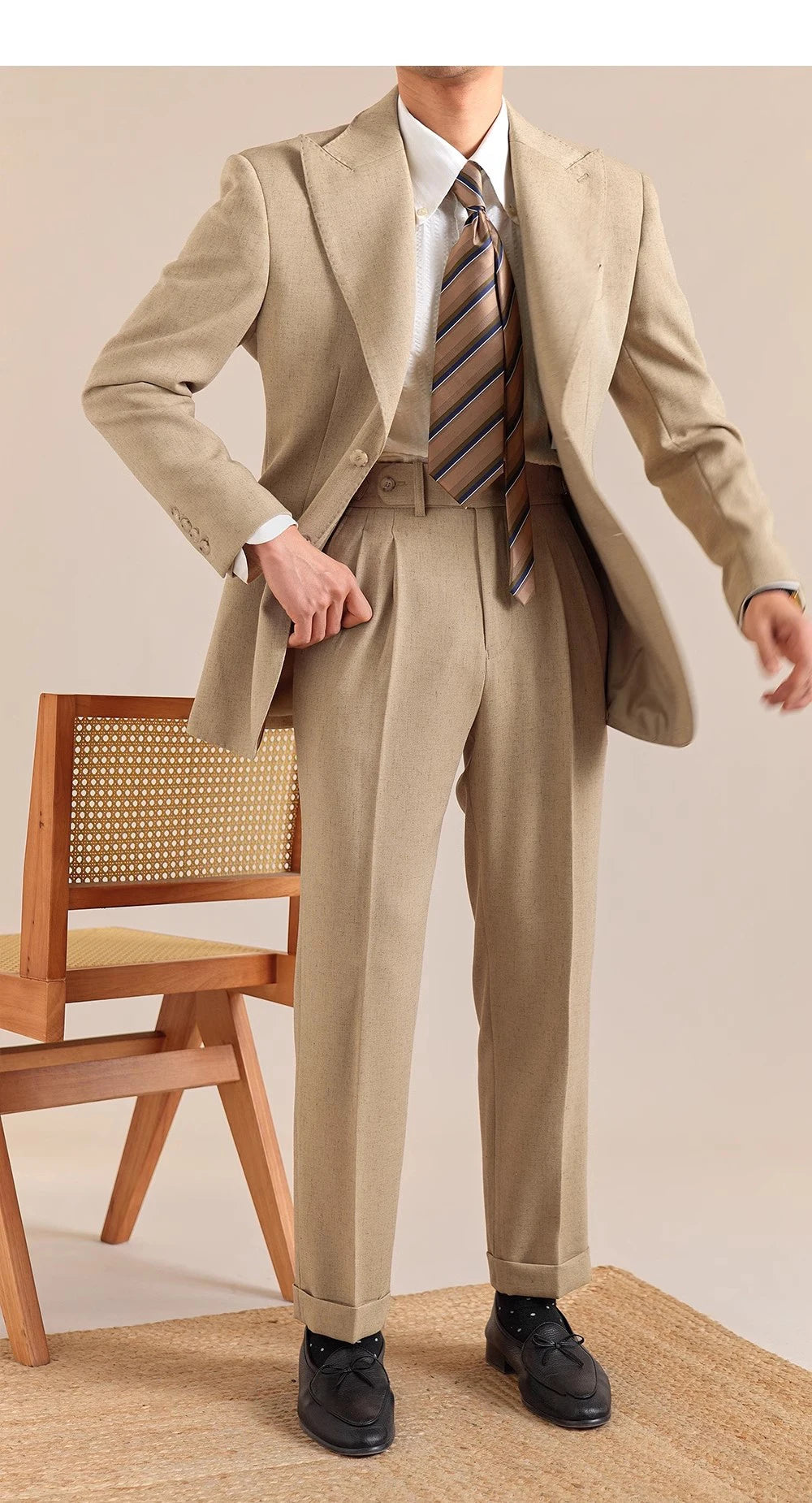 Model wears matching blazer and cropped trousers in Sandrift—tonal linen-blend set with tailored ease. From Borcelleclothes.