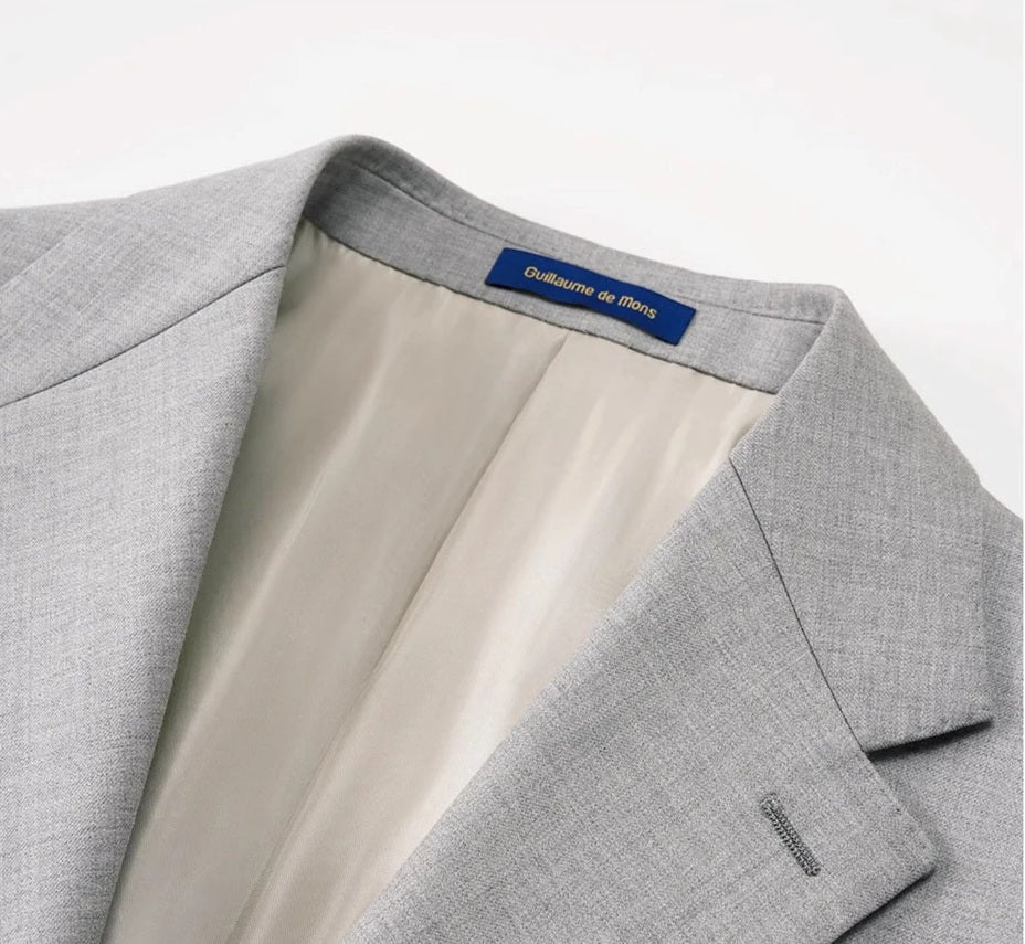 Upper section of the blazer showcasing sharp notch lapels and brown horn buttons on the Nobel wool suit. From Borcelleclothes.