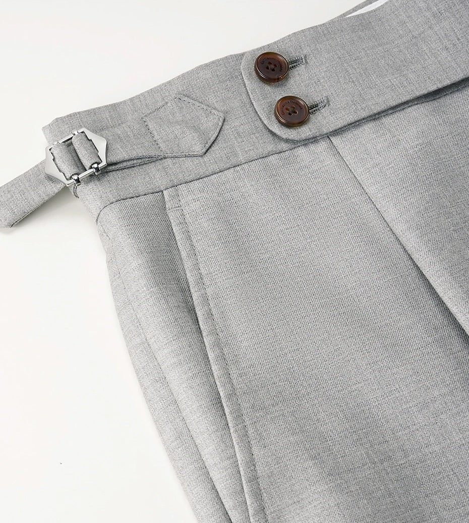 Detail of the pants’ adjustable side buckle with two-button closure, combining function with formal grace. From Borcelleclothes.