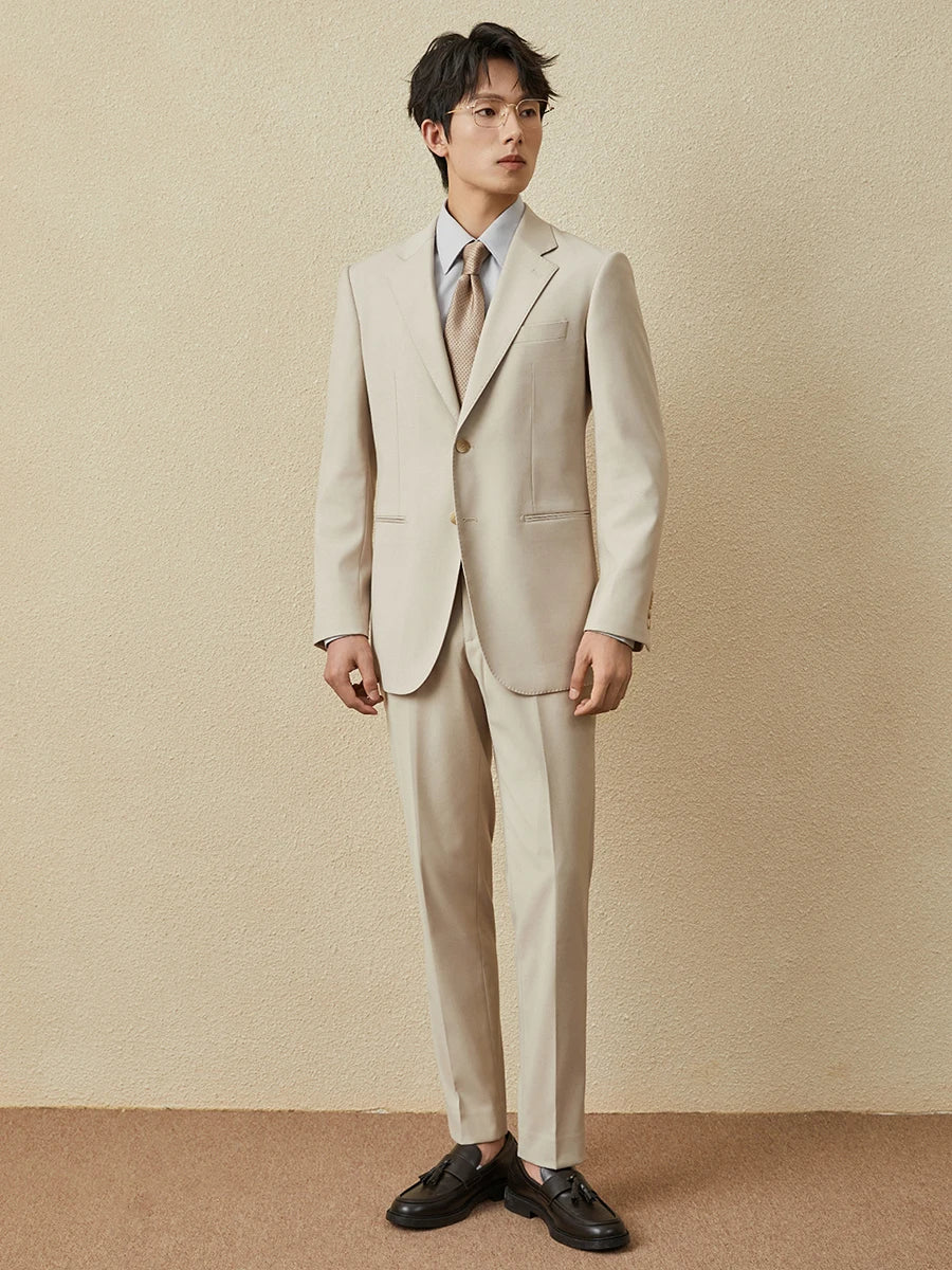 Model wearing the notched lapel suit in Ash with arms straight, showcasing the full silhouette. From Borcelleclothes.