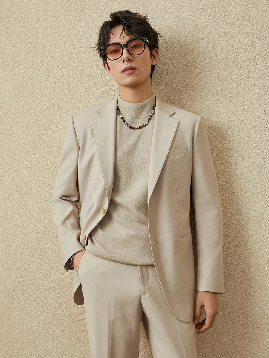 Model wearing the Ash suit with a cashmere sweater and a subtle strand of beads. From Borcelleclothes.