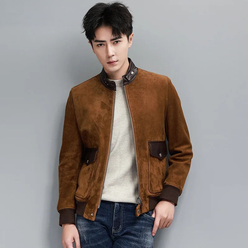 Nutmeg Suede Bomber — model with thumb in jeans pocket; leather stand collar and rib cuffs, quiet luxury silhouette. From Borcelleclothes.