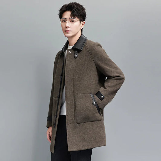 Men’s Makara wool-cashmere coat with raglan sleeves and leather accents on collar, placket, and cuffs, inspired by the mythical guardian Makara — blending softness and strength. From Borcelleclothes.