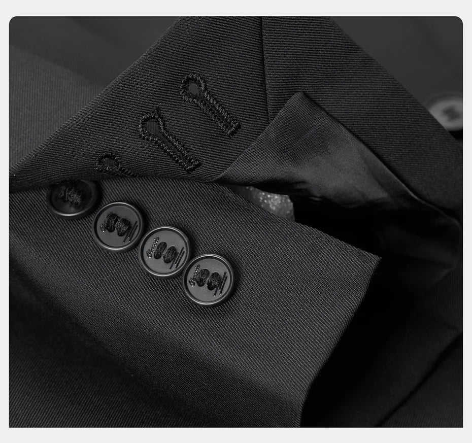 Unfastened sleeve placket with button detail on the blazer, showing craftsmanship and structure. From Borcelleclothes.