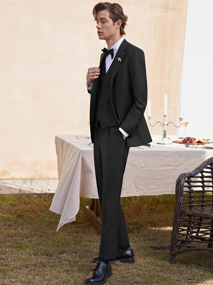 Model in an Onyx suit gently adjusting his lapel, highlighting the blazer’s precise tailoring. From Borcelleclothes.