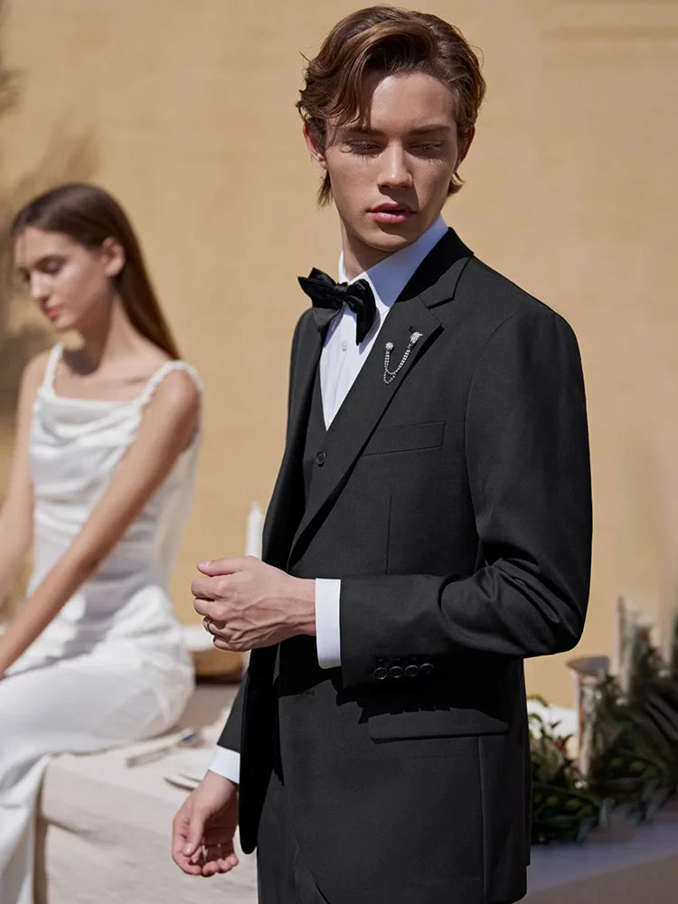 Men’s Onyx wool-blend suit featuring a single-breasted blazer with notch lapels, a buttonhole detail, and pleated trousers with side adjusters. From Borcelleclothes.