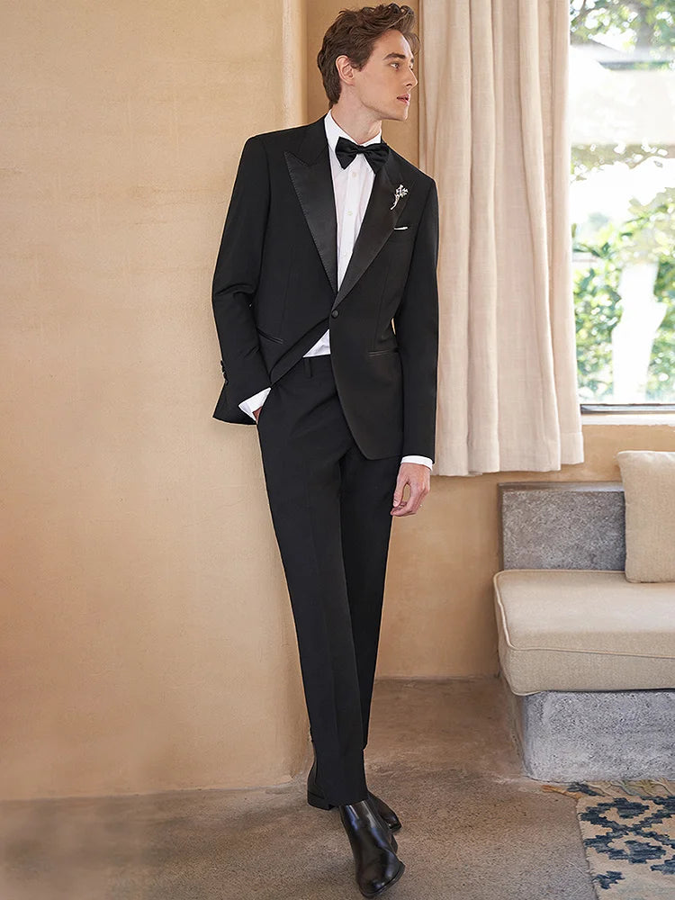 Model with hand in pants pocket wearing Onyx Wool Tuxedo — showcasing effortless formal style. From Borcelleclothes.