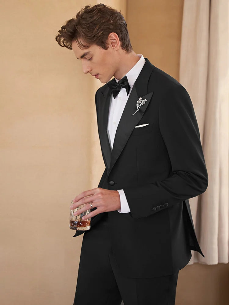 Model holding a whiskey glass in Onyx Wool Tuxedo — capturing the essence of refined evening moments. From Borcelleclothes.