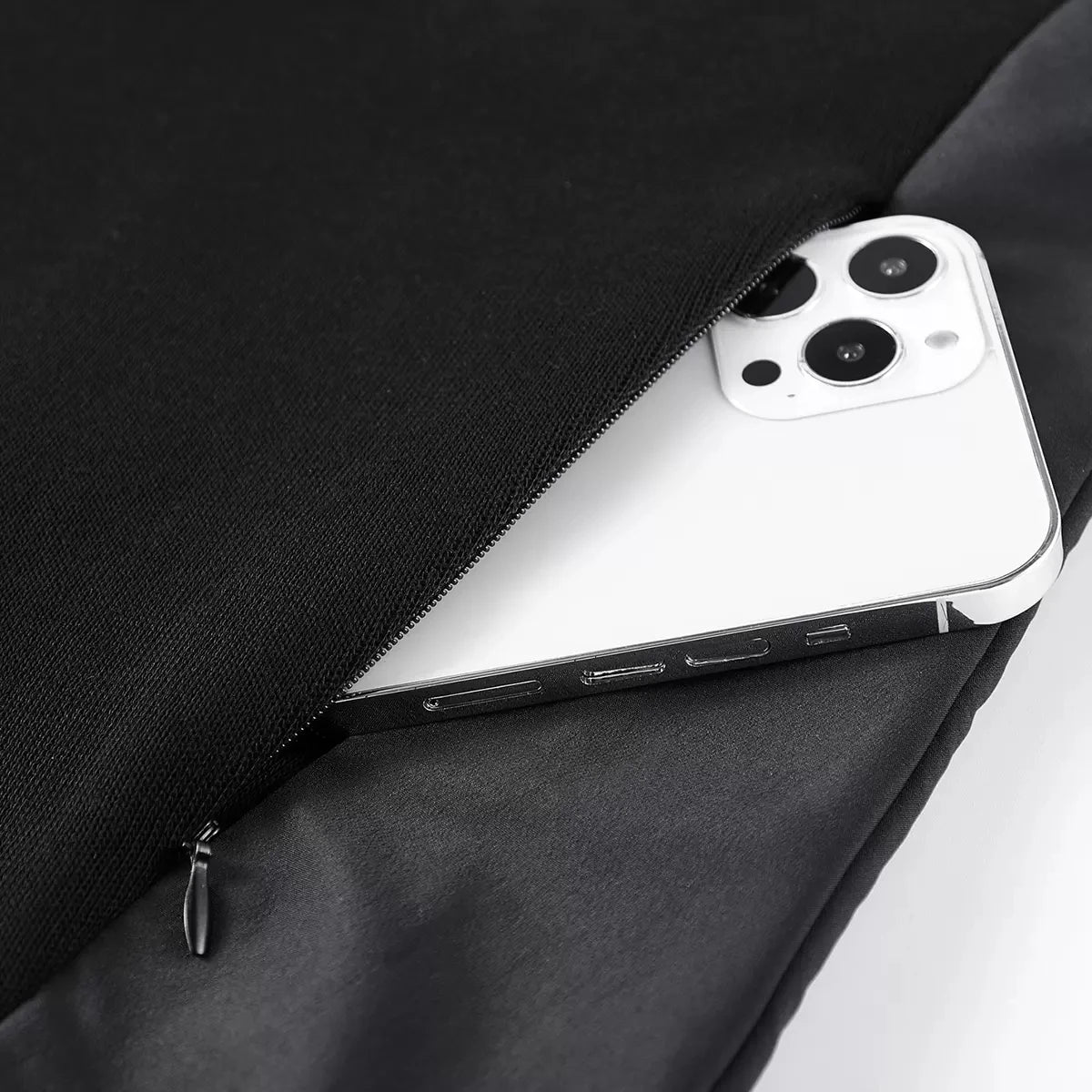 Invisible side zipper pocket on the Onyx men's patchwork sweatshirt, shown with phone. From Borcelleclothes.