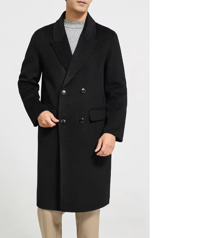 A model wearing the Men's Peaked-Lapel Wool Coat in Onyx, placing a hand in the pocket, highlighting the sleek integration of the flap pocket into the structured silhouette. From Borcelleclothes.