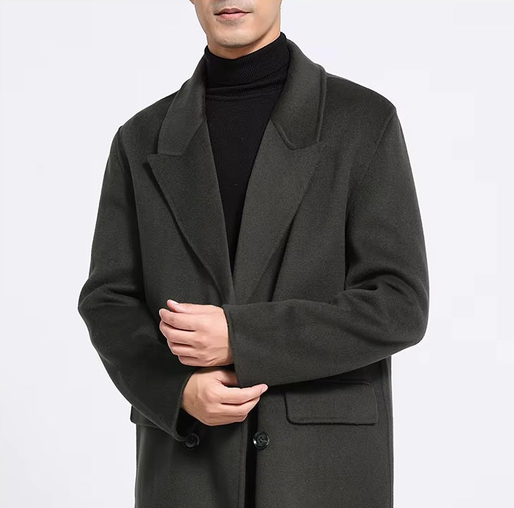 The upper part of the Men's Peaked-Lapel Wool Coat in Tuatara, highlighting the structured lapels and double-breasted front. From Borcelleclothes.