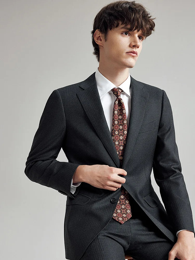 Model seated in the Borcelleclothes Men's Steel Grey Pinstriped Suit, highlighting the suit's versatile and refined design for formal occasions.