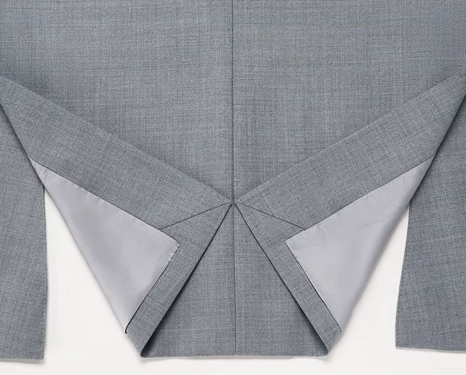 The folded back double vent on the Borcelleclothes Men's Storm Grey Slim-Fit Suit blazer, emphasizing mobility and sleek design.