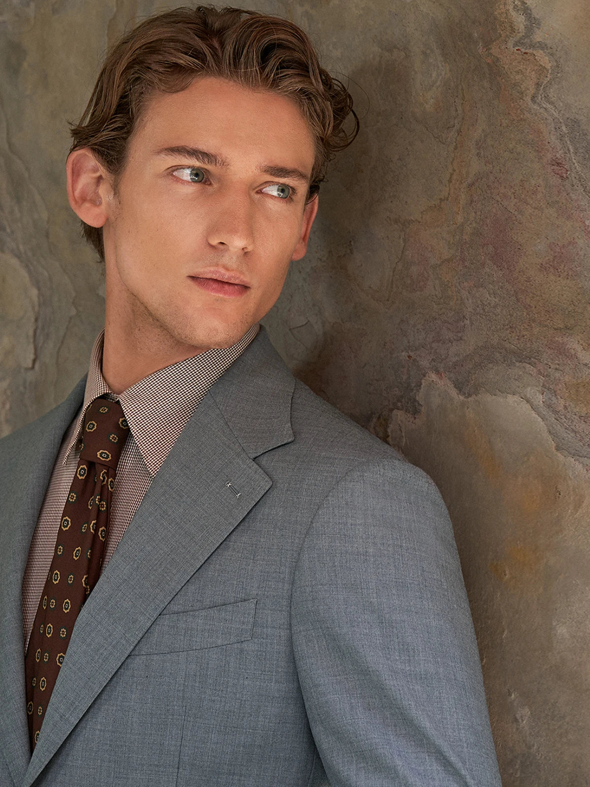 Model wearing the Borcelleclothes Men's Storm Grey Slim-Fit Suit, gazing to the side, highlighting the suit's elegant details and sharp silhouette.