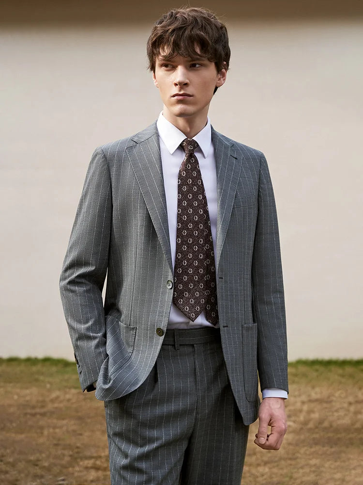 Model in Storm Grey wool suit with one hand in pocket, embodying confident elegance. From Borcelleclothes.
