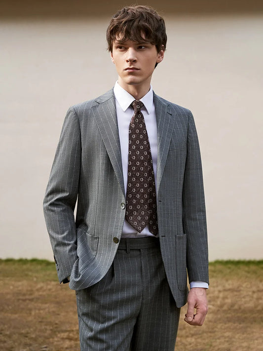 Model in Storm Grey wool suit with one hand in pocket, embodying confident elegance. From Borcelleclothes.