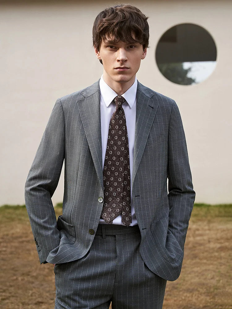 Model with both hands in trouser pockets, highlighting the relaxed structure of the Storm Grey suit. From Borcelleclothes.
