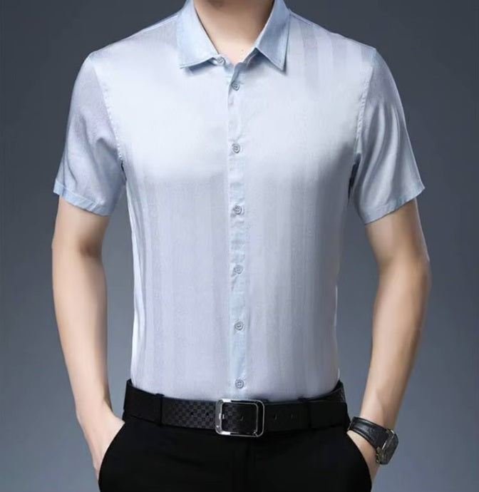 Men's Mulberry Silk Shirt from the Striped Collection in Link Water, showcasing a refined minimalist design with subtle stripes that shift in visibility through the interplay of matte and glossy surfaces, highlighting its luxurious and dynamic quality. From Borcelleclothes.