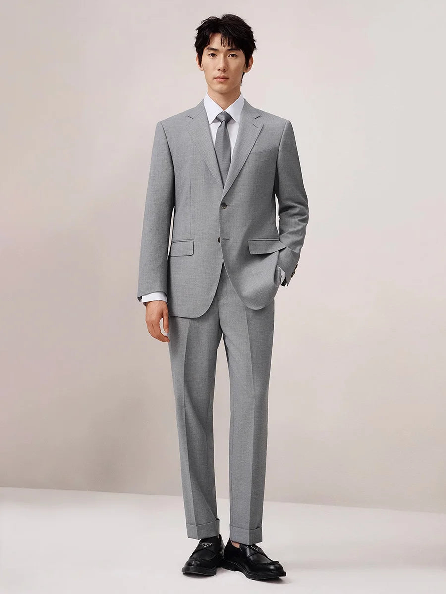 Model with one hand in pants pocket, highlighting the relaxed tailoring and cuffed hem. From Borcelleclothes.