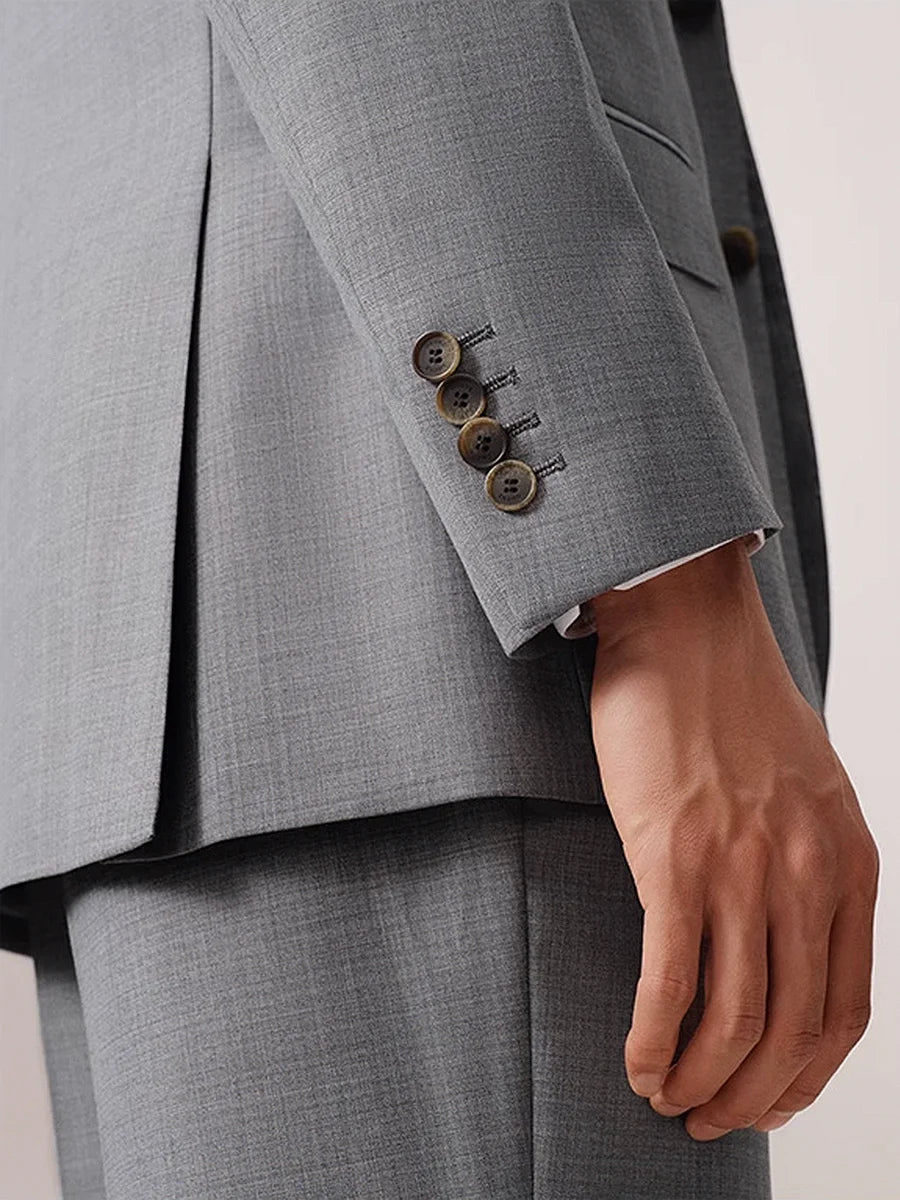 Close-up of model’s sleeve placket with four horn buttons and handmade buttonholes. From Borcelleclothes.