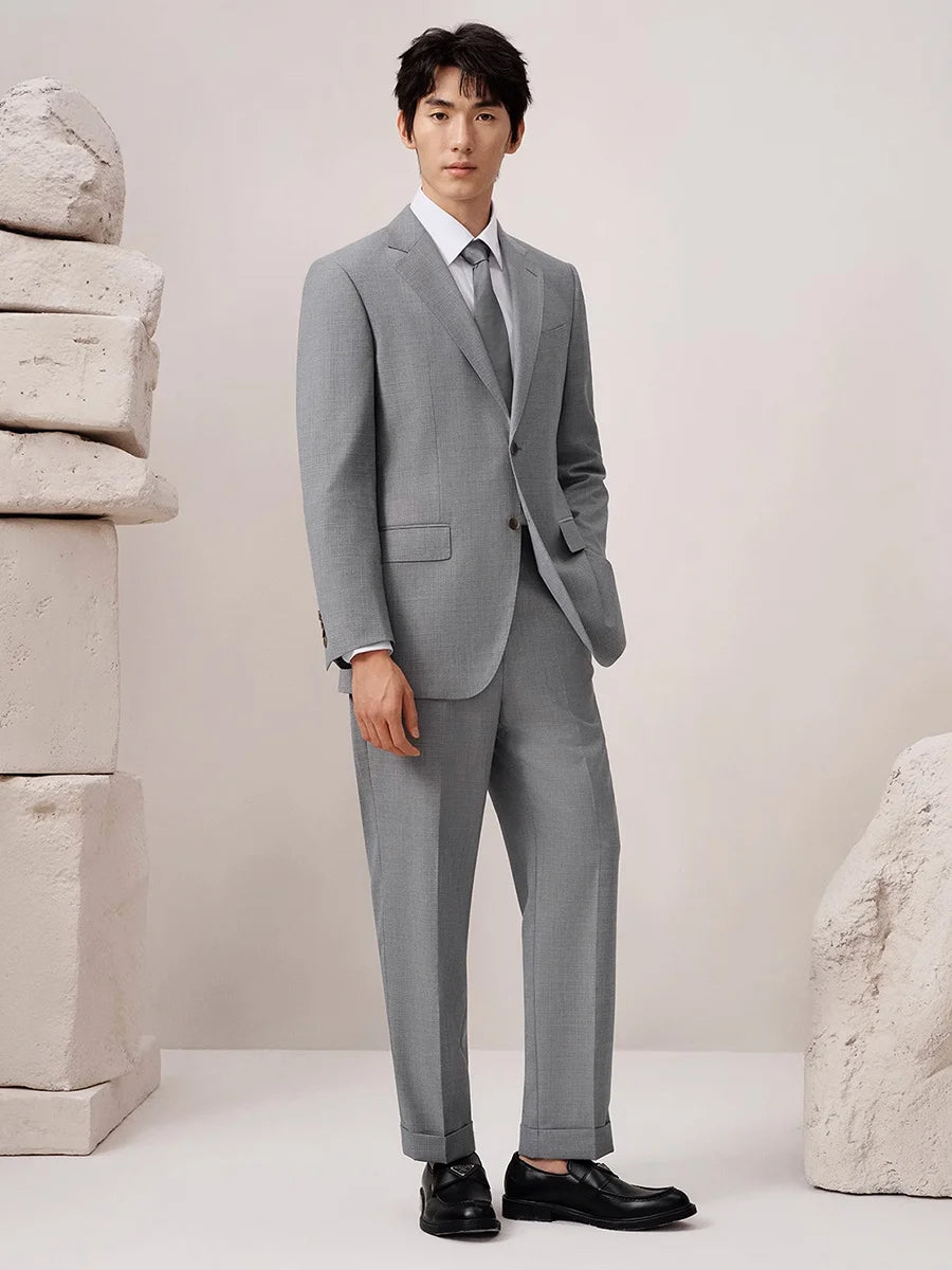 Model slightly turned to the side, showing the soft drape and fit of the melange wool fabric. From Borcelleclothes.