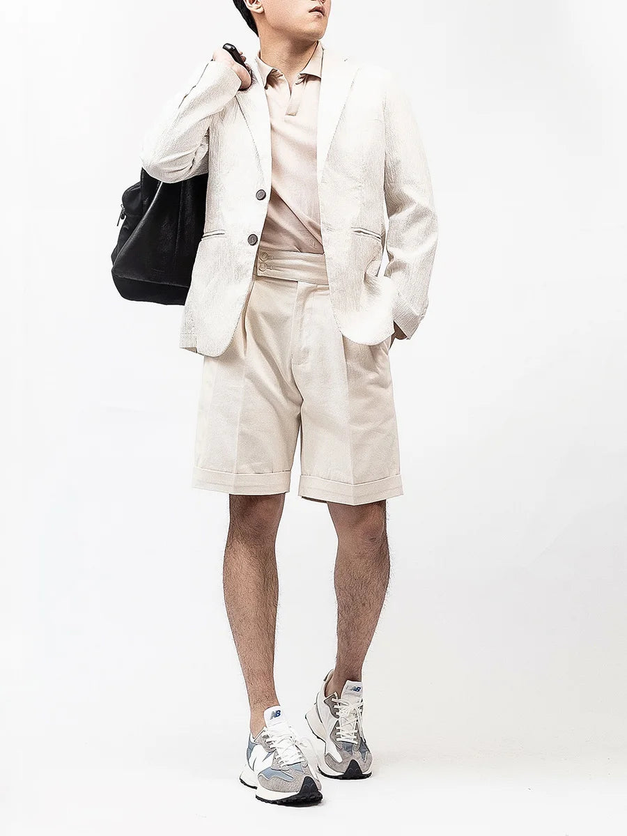 Model wearing Swiss Coffee tailored shorts with a bag slung over the shoulder, balancing structure with relaxed confidence. From Borcelleclothes.