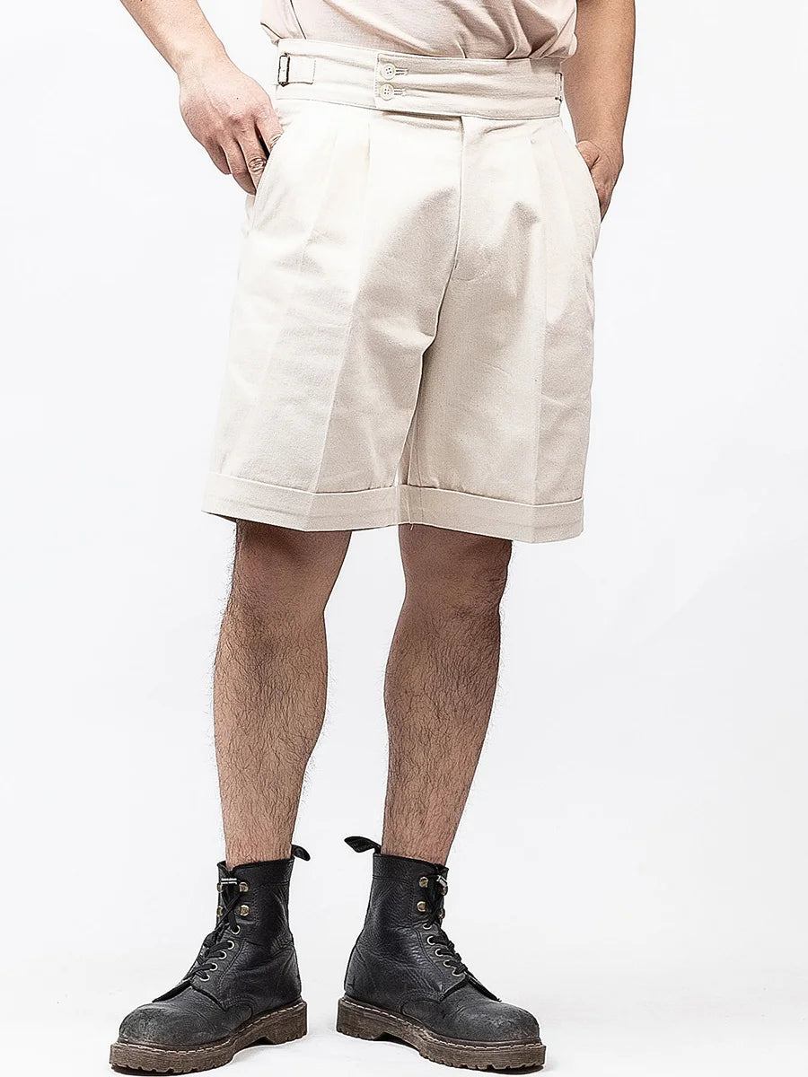 Men's structured Swiss Coffee tailored shorts, crafted from dense cotton with front pleats and a clean silhouette—offering composed elegance and quiet strength for refined summer dressing. From Borcelleclothes.