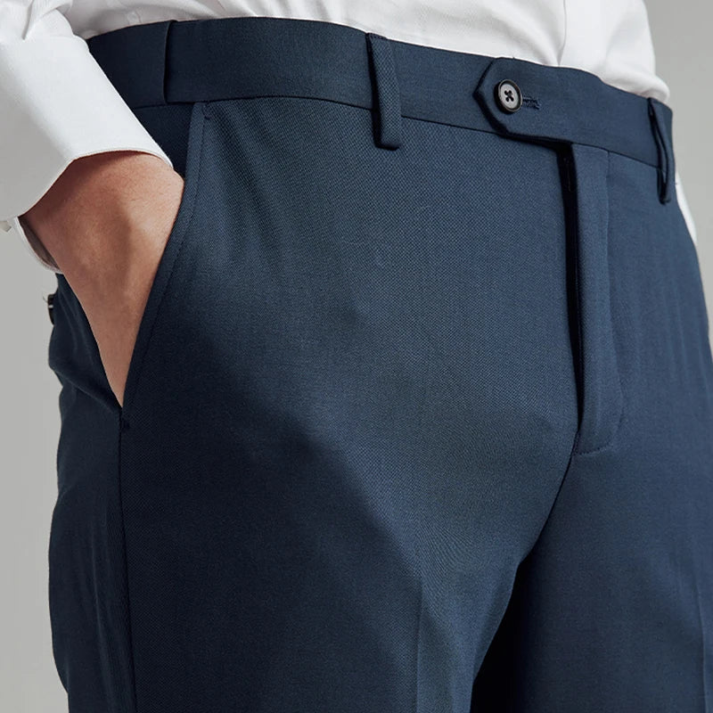 Front upper view of the River Bed trousers on model, featuring a tailored waistband with belt loops and side adjusters. From Borcelleclothes.