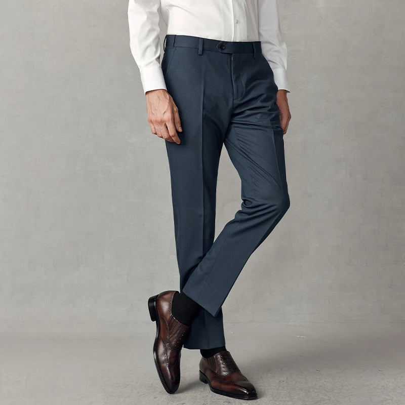 Men's Tailored cropped trousers in River Bed color with slim silhouette, clean hem, and discreet side adjusters. From Borcelleclothes.