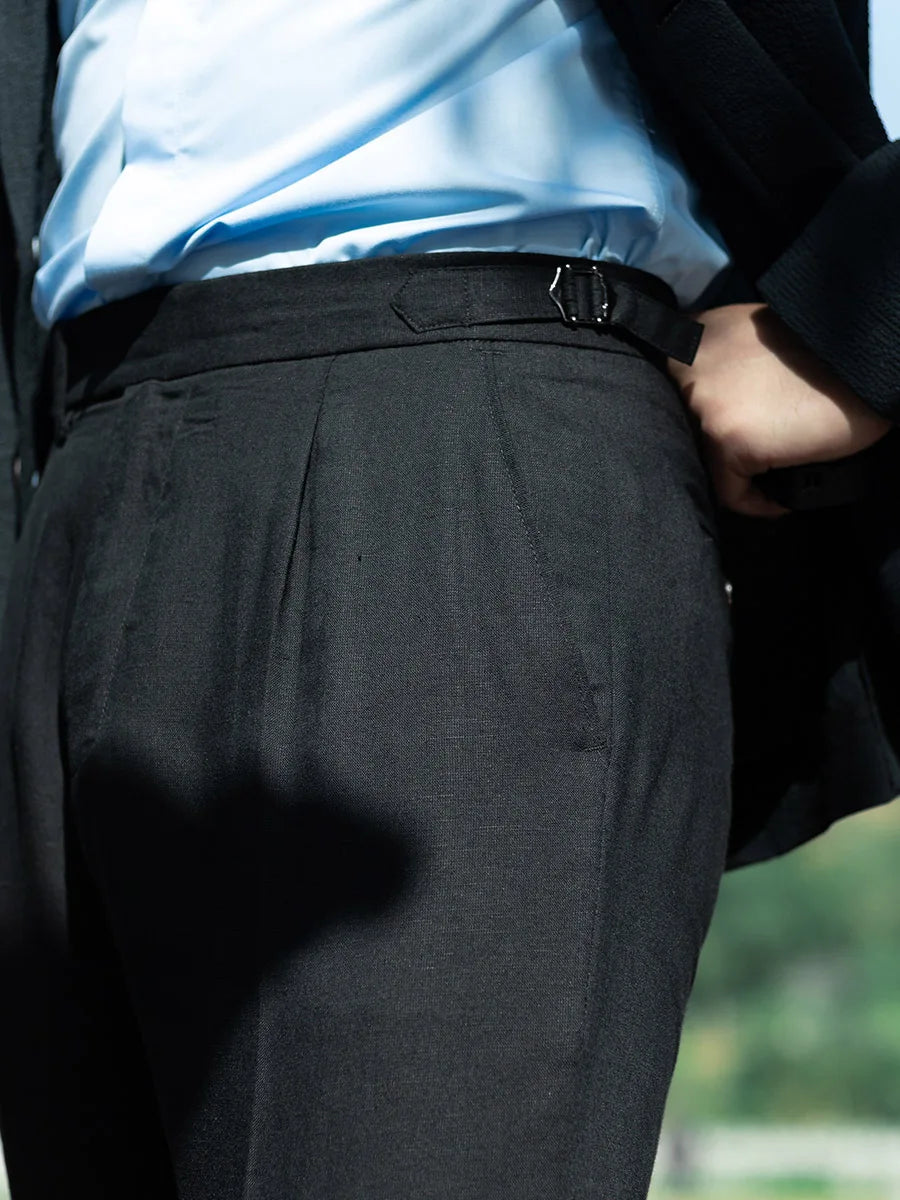 Close-up of adjustable side belt on men’s linen trousers in Onyx, highlighting the refined waist construction. From Borcelleclothes.