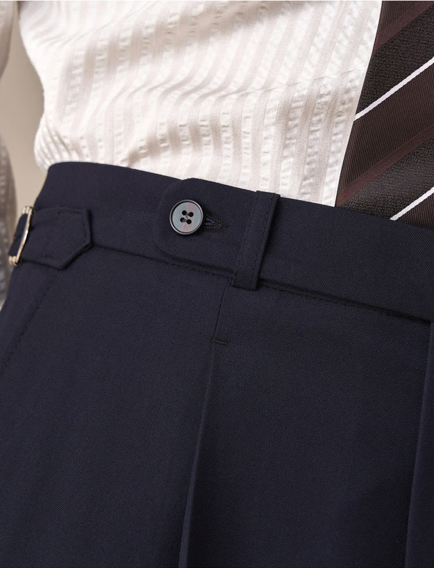Close-up of waistband with buttoned extension and guiding loop on Midnight Express trousers. From Borcelleclothes.