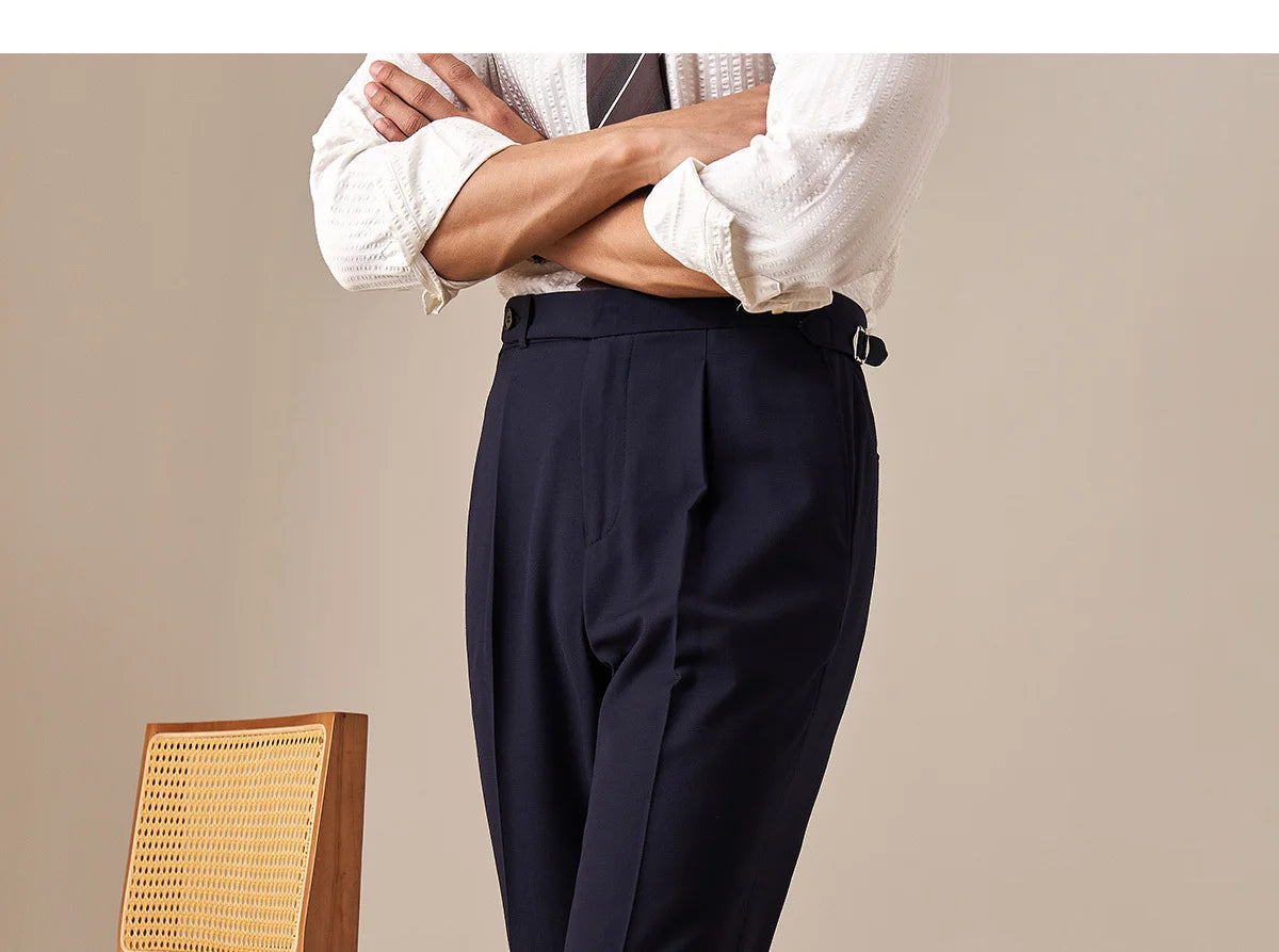 Model standing with arms crossed, wearing Midnight Express trousers, styled in composed stance. From Borcelleclothes.