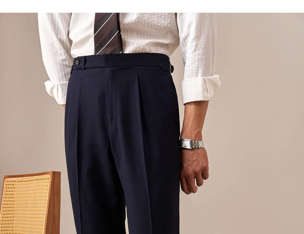 Model in Midnight Express trousers with one hand behind back, emphasizing clean tailored silhouette. From Borcelleclothes.