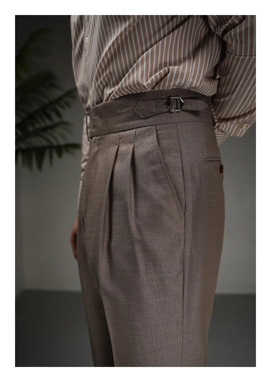 Model with hand behind back wearing Wenge trousers, highlighting waistband and structured stance. From Borcelleclothes.