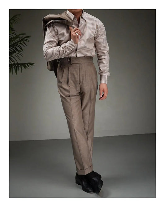 Model wearing tailored wool-blend trousers in Wenge, holding matching jacket over shoulder. From Borcelleclothes.