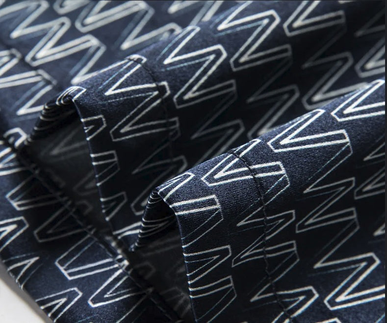 Hemline of the silk polo with W pattern design, softly structured and fluid in motion. From Borcelleclothes.