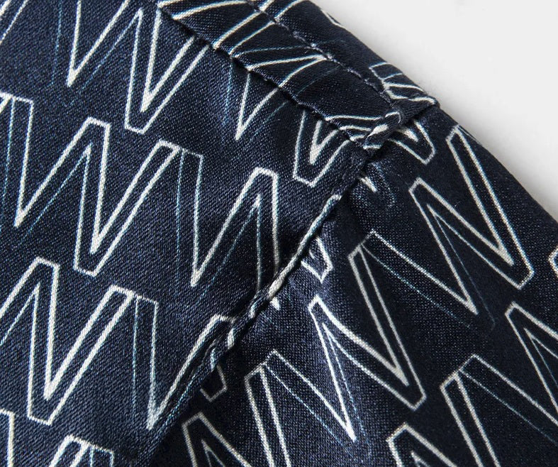 Structured shoulder detail on the Mulberry silk polo, subtle print in a deep midnight hue. From Borcelleclothes.