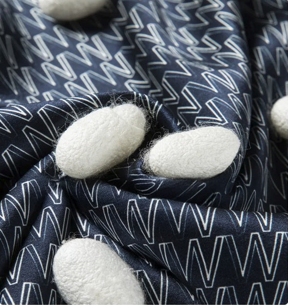 Printed W Pattern Mulberry Silk Polo in Midnight Express with white silk cocoons on the fabric surface. From Borcelleclothes.