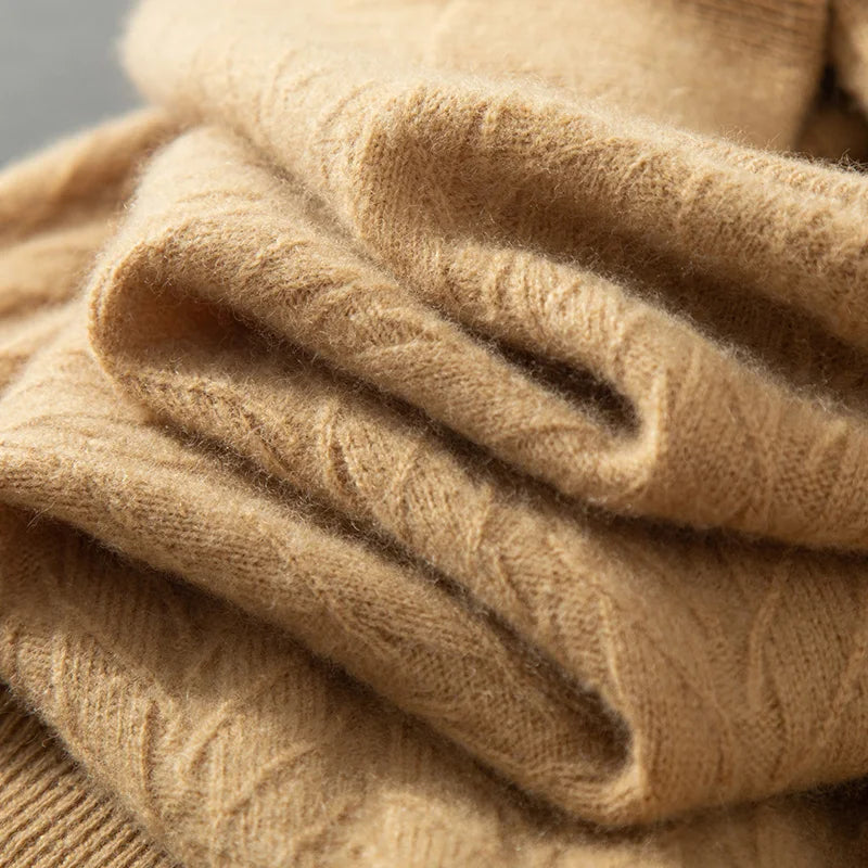 Vertically serpentine-folded texture of the Men's Wheat Spikes Alashan Cashmere Sweater in Lion, showcasing the fine detailing of its luxurious cashmere fabric and wheat spike pattern. From Borcelleclothes.